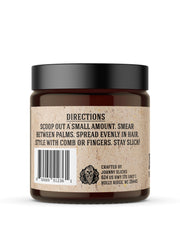 Johnny Slicks 2 oz tin held in hand demonstrating travel-friendly convenience