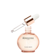 KÉRASTASE bottle front view showing sleek design and glossy finish benefit