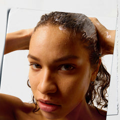 Kiehl's pump dispensing conditioner into hand for convenient controlled use