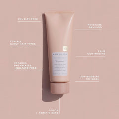 Applying Kristin Ess co-wash to wet hair for gentle cleansing and slip