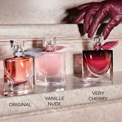 Lancôme bottle held in hand to show compact 1 fl oz size and travel convenience