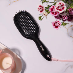 L'ANGE HAIR brush hanging from shower strap for convenient storage and drying