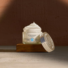 L'OCCITANE cream on bathroom counter staged with towel, suggesting daily routine benefit