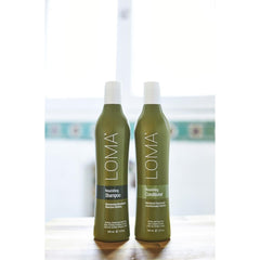 Loma conditioner being applied in shower for smoother detangling