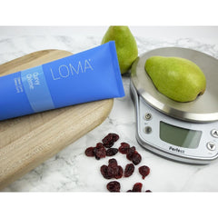 Loma Curvature textured crème on fingertips showing creamy consistency