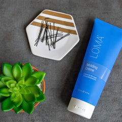 Loma molding crème styled curly hair lifestyle shot showing defined volume benefit