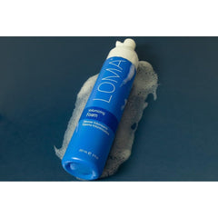 LOMA volumizing foam close-up label highlighting paraben-free and thermal protection benefits