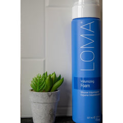LOMA volumizing foam white mousse texture dispensed to show lightweight, airy hold