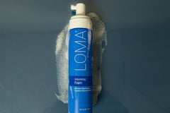 LOMA volumizing foam in hand being applied to damp hair for instant root lift
