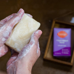 Person using Lume bar to wash hands showing gentle foaming and effective rinsing benefit