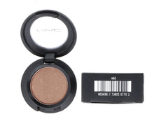 MAC Woodwinked next to coin showing 1.5g compact, travel-friendly size