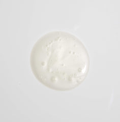 MALIN+GOETZ shampoo in hand being applied to hair showing easy dispense and gentle cleanse