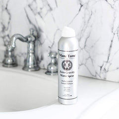 Mane Tame spray misting through hair to create instant texture and volume