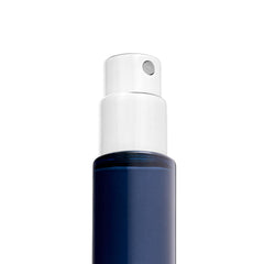 Michael Malul travel spray next to passport showing 10ml size ideal for carry-on