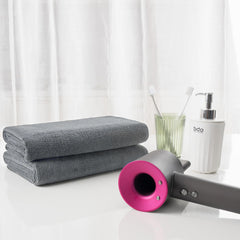 MICROFI towels folded beside ruler showing generous size and coverage advantage