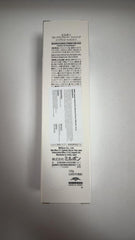 Milbon 4.2 oz tube next to a hand for size and portability reference