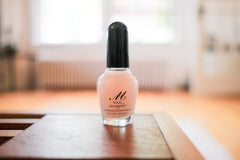 Nail Magic brush and applicator poised to show easy, precise application benefit