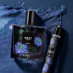 NEST New York Indigo in a beach bag lifestyle image suggesting portable fragrance refreshes