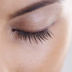 NutraLuxe Lash MD vial in hand showing 1.5ml size for travel