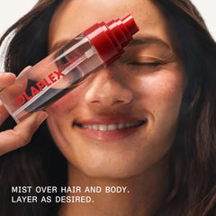 Olaplex mist beside everyday items to show 80 mL size for travel convenience