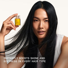 Olaplex No.7 droplet on a single hair strand showing smoothing and gloss
