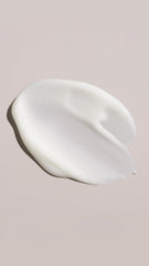 Oribe conditioner applied to damp hair in hand demonstrating easy distribution and detangling benefit