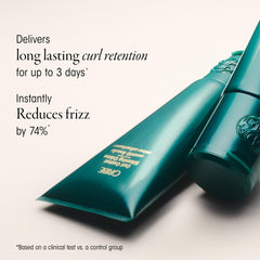 Oribe cream applied to damp hair to define curls and reduce frizz
