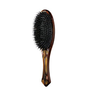 Oribe flat brush front view showing elegant resin and sleek finish benefit shine