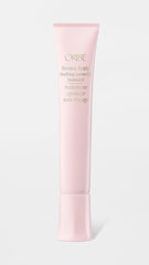 Oribe product texture on fingertip highlighting lightweight, fast-absorbing formula for comfort