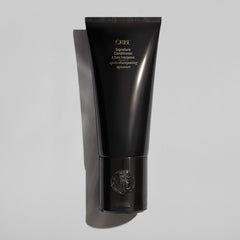 Creamy conditioner swatch from Oribe showcasing rich texture and hydrating finish