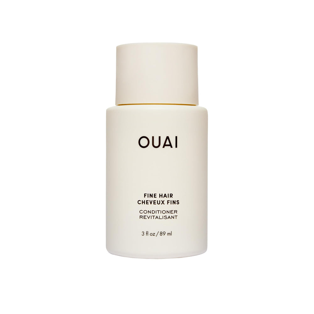 OUAI front view of travel conditioner tube shows brand and easy packing benefit