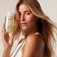 OUAI 32oz bottle beside a standard bottle showing salon-size value and longevity