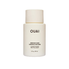 OUAI front bottle showing travel-size packaging and portability benefit
