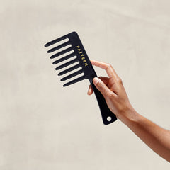 PATTERN comb being used to detangle curly hair for smoother styling