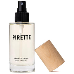 PIRE TTE glass bottle front view showing elegant beach-inspired design and portability