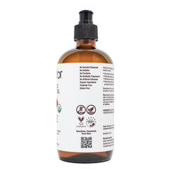 PURA D'OR oil being poured showing smooth cold-pressed texture and absorption