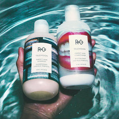 R+Co Television conditioner cream texture on fingertip illustrating smooth detangling benefit
