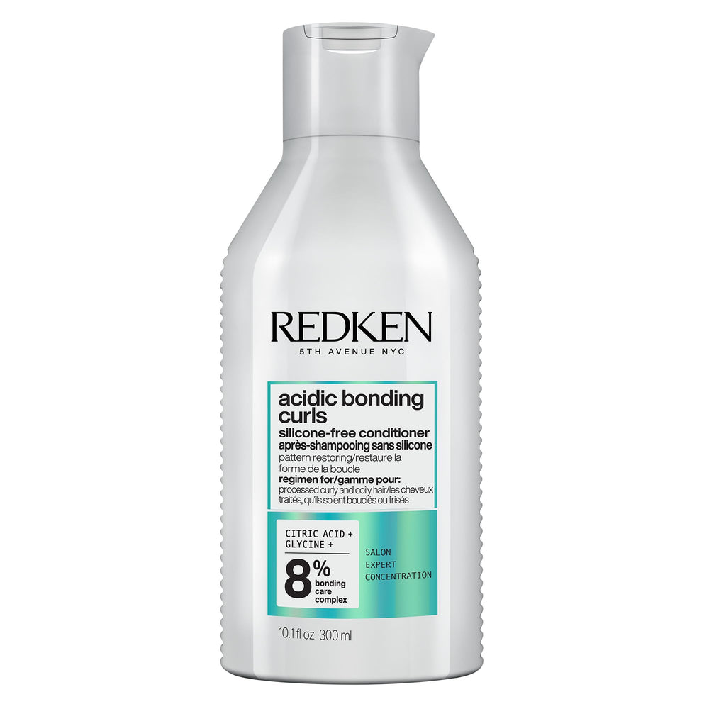 Redken bottle front packaging showing product identity and benefits