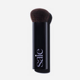 Saie brush front view showing sleek handle and dense head for even application