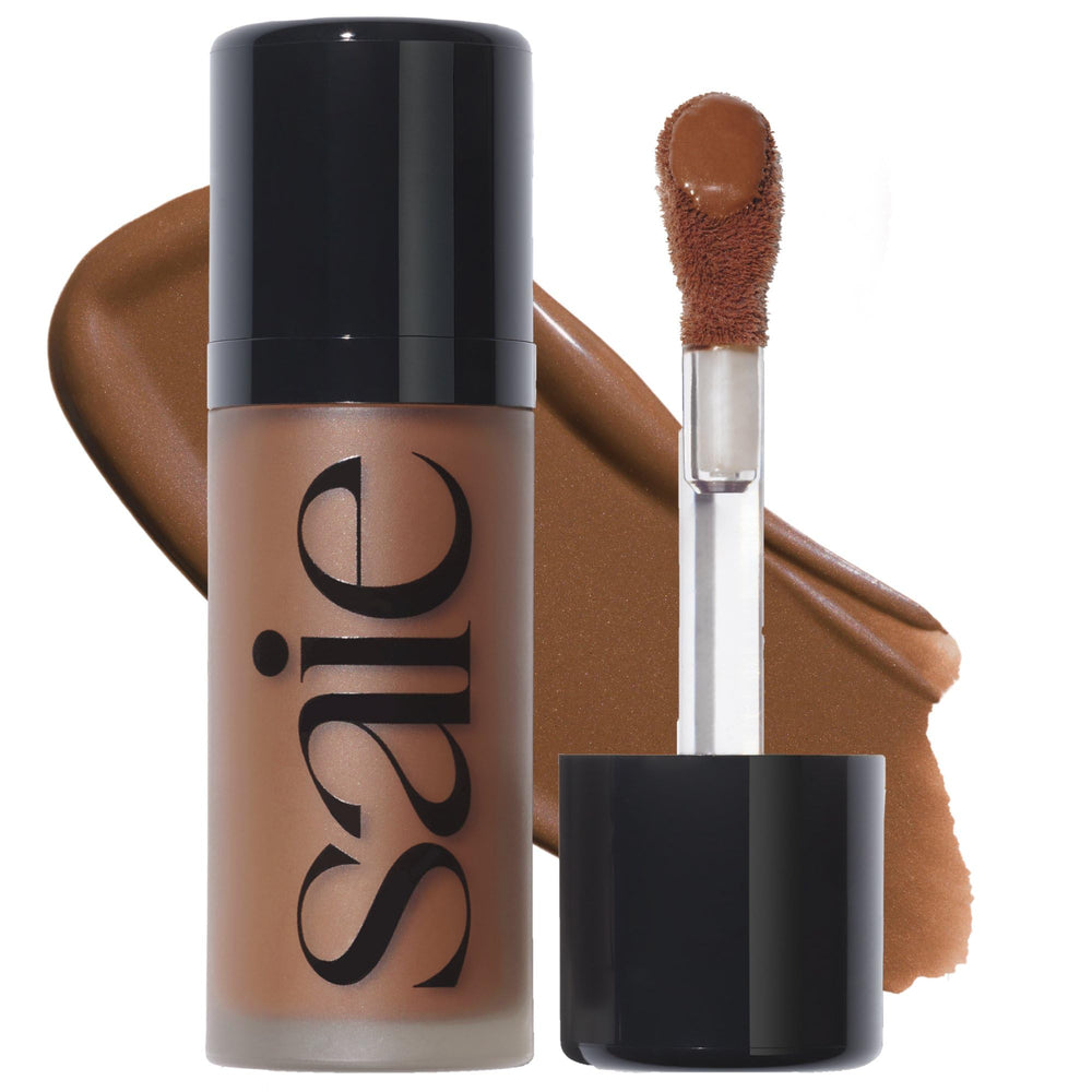 Saie Dew Bronze front stick showing compact travel-ready packaging and effortless bronze