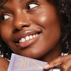 Saie Sunvisor blended on skin demonstrating sheer golden glow