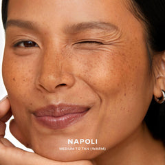 Model with medium-tan skin wearing Saie SuperSuede Napoli for natural warmth
