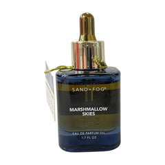 Sand + Fog deep blue bottle front view showing elegant gold cap and protective glass