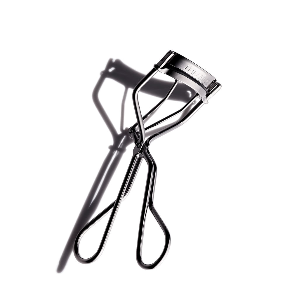 Shiseido eyelash curler front view showing broad curve for fuller curl