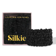 Silkie midnight front packaging showing six black silk scrunchies and pouch, polished presentation benefit