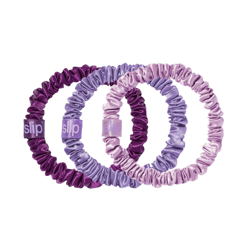 SLIP front packaging with three violet silk scrunchies shows soft luxury