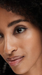 stila swatch of midnight on arm showing rich deep-blue payoff benefit