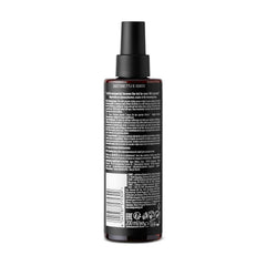 STMNT grooming spray in hand application over damp hair illustrating easy control and faster styling