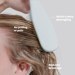 TANGLE TEEZER held in hand to show size and convenient travel scale