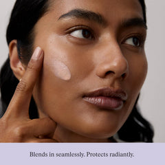 Model applying TATCHA sunscreen for even tone and visible radiance benefit